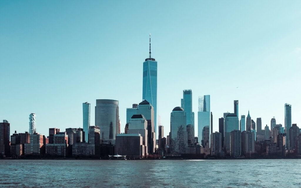 City skyline across body of water during daytime
